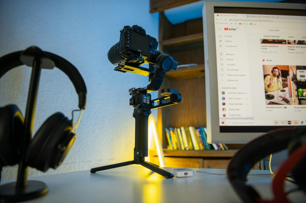 Youtube content creation setup with camera, headphones and computer screen for video automation